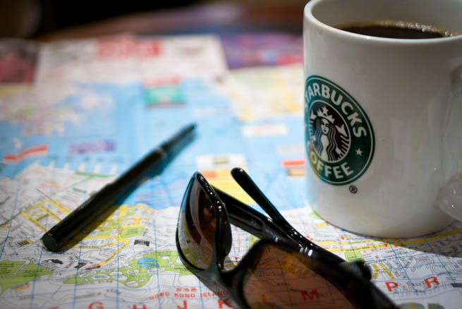 Use these helpful tips to decide where you should take the perfect vacation! A traveler plans his trip using a map, a pen, and lots of coffee.