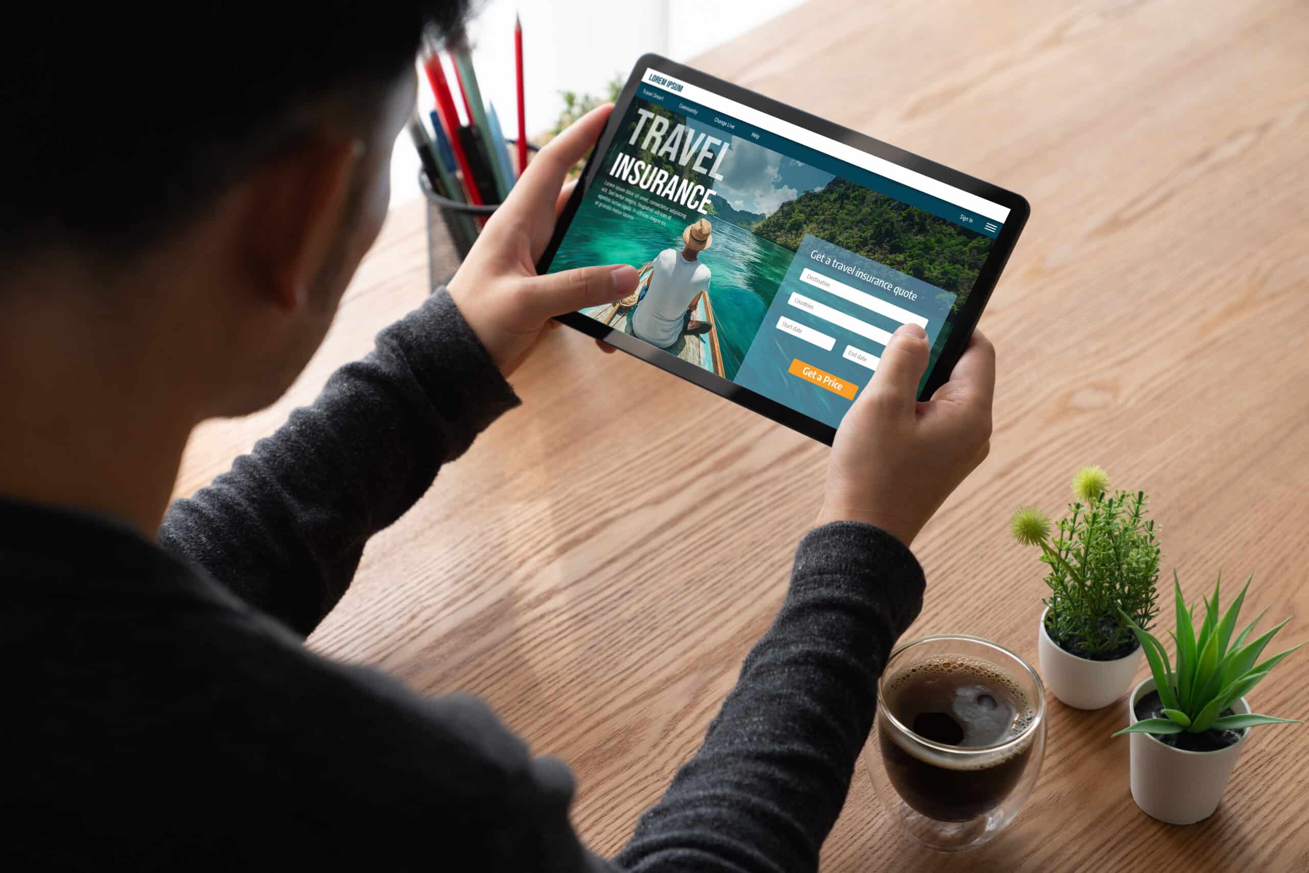 man buying travel insurance on tablet