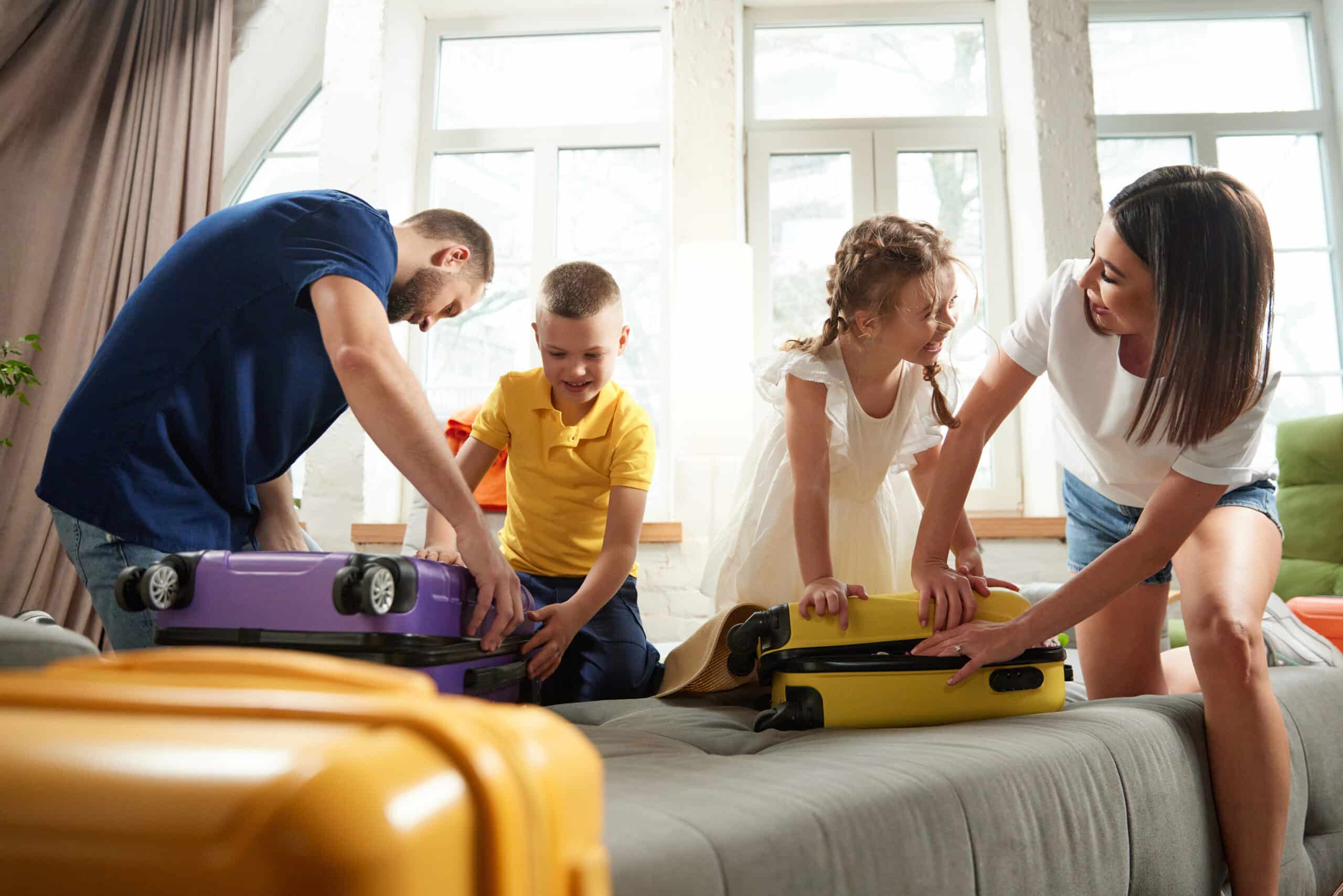 Family packing luggage for trip