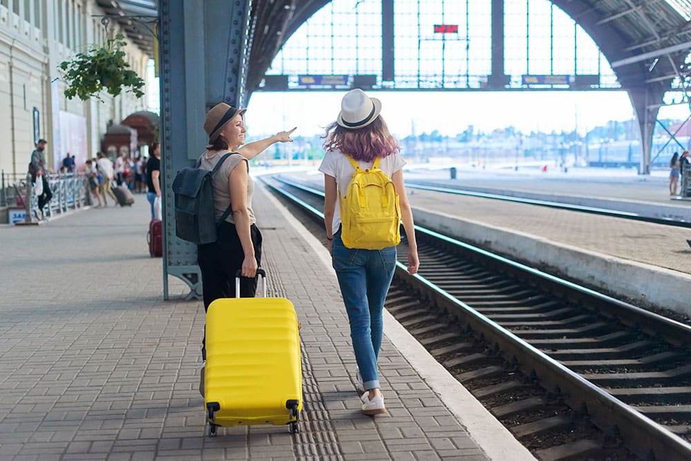 two women travelers waiting for train